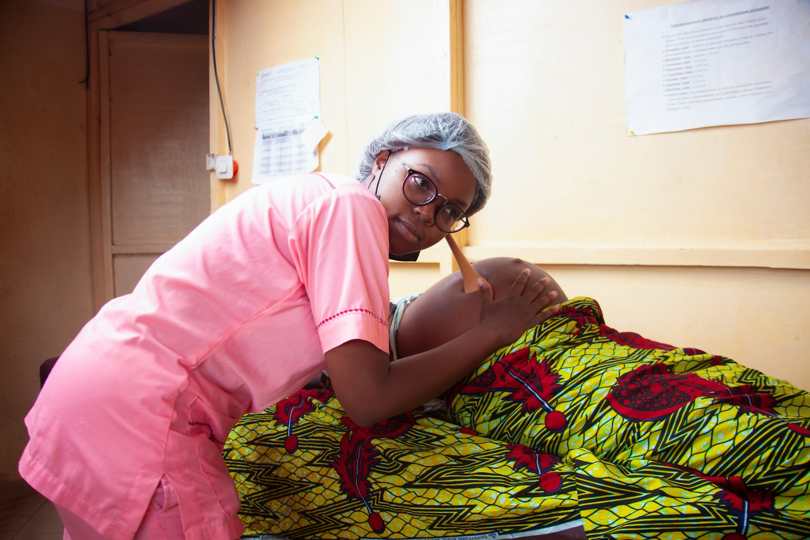 A care provider checking in with a pregnant client during a prenatal visit